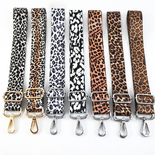 Set of big cat print phone straps with gold and silver clasps on a white background