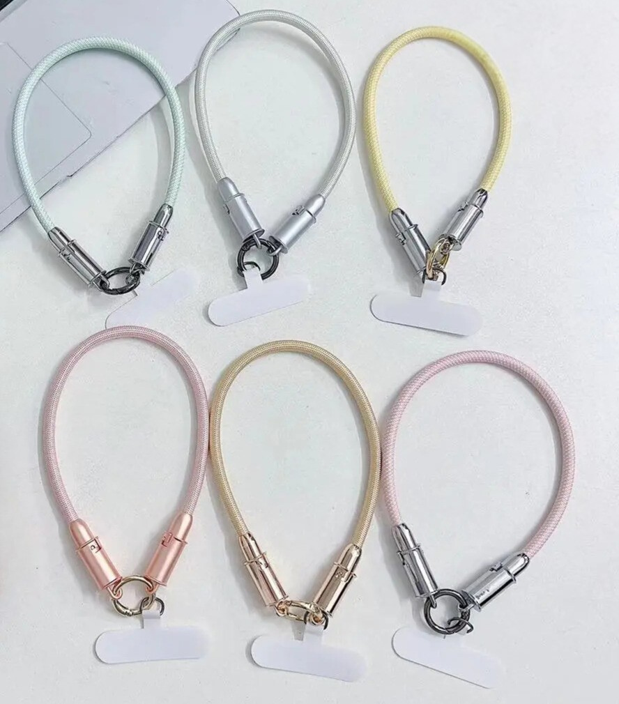 set of six different coloured phone wrist straps that are also phone charging cables  with universal phone tethers, shown against a white background
