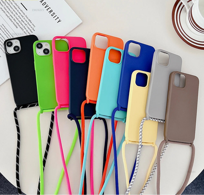 Colorful phone cases with straps on a white surface