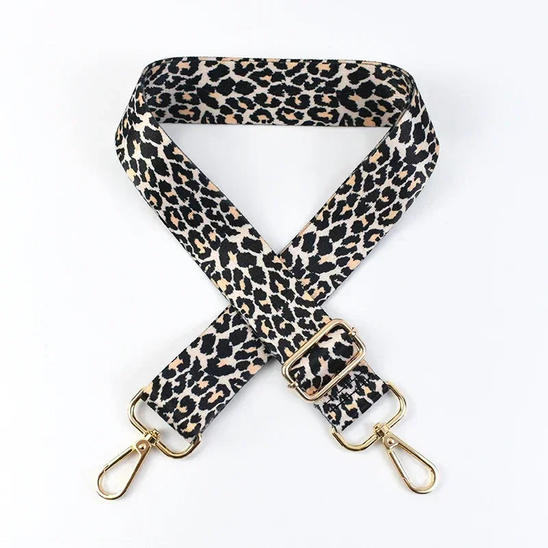 Lynx print phone strap with gold hardware on a white background