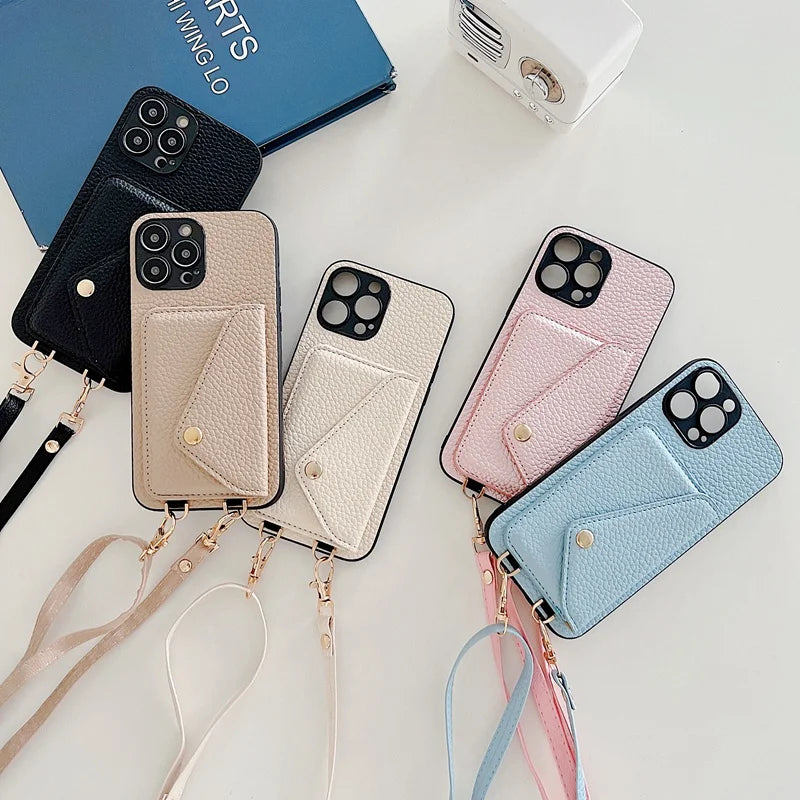 Five leather phone cases with lanyards in different colors on a white surface.