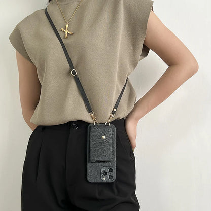 Person wearing a black leather phone case with strap against a light background