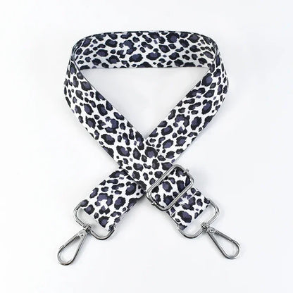 Snow Leopard Big Cat print phone strap in black, white and grey with metal hardware on a white background