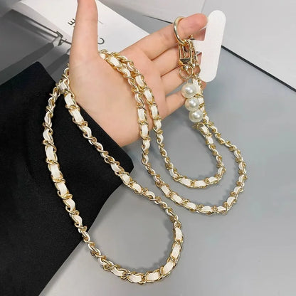 Elegant leather-look cross body phone strap with metal and pearl detailing