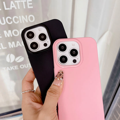 Black and pink phone cases held by a hand with a blurred background