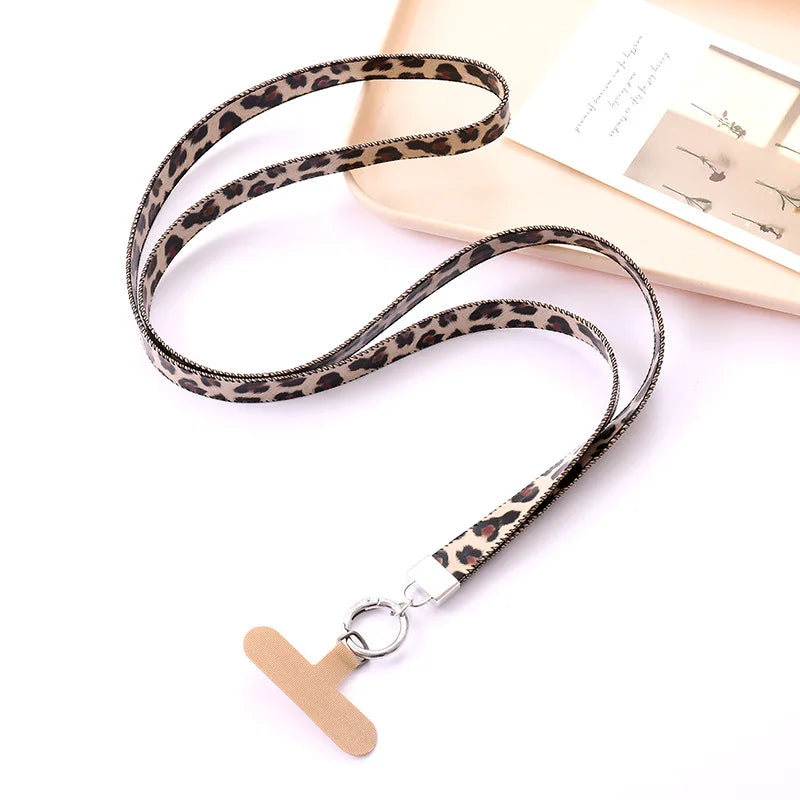 Leopard print lanyard with a beige universal phone tether on a white background