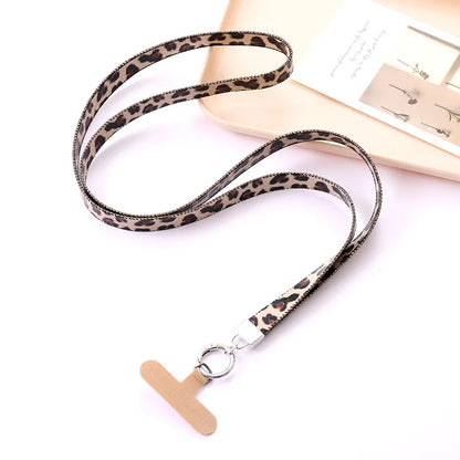 Leopard print lanyard with a beige universal phone tether on a white background