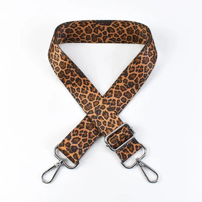 Leopard print phone strap with metal clasps on a white background