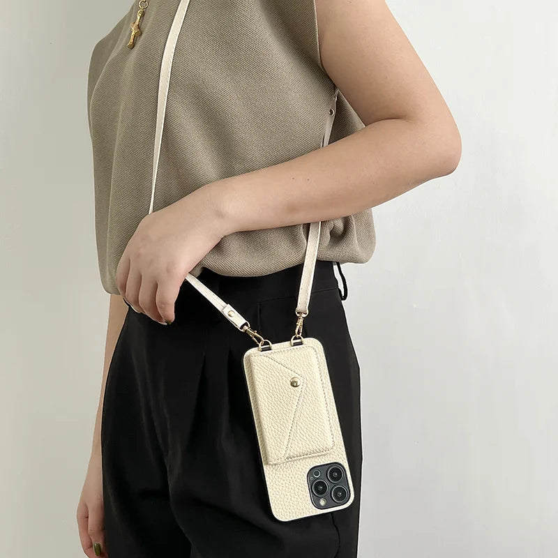 Person wearing an beige leather phone case with strap against a light background