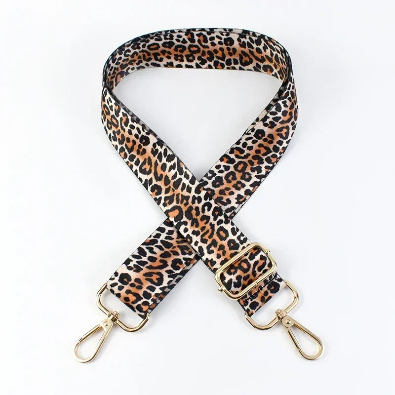 Jaguar print phone strap with gold hardware on a white background