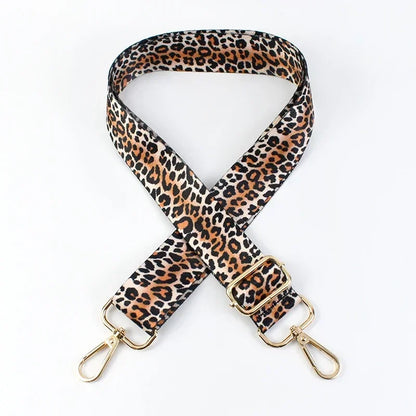 Jaguar print phone strap with gold hardware on a white background