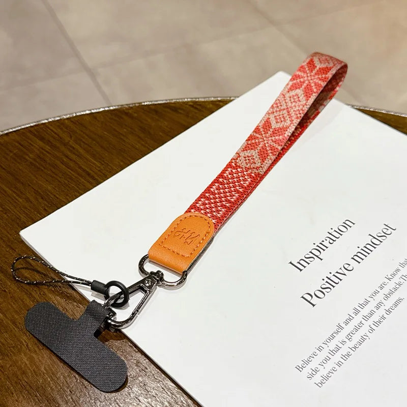 Red patterned strap with orange buckle on a book