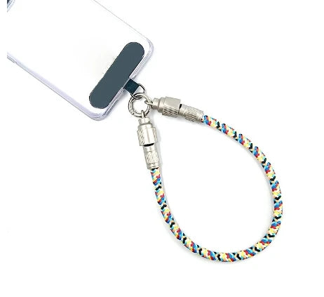 Colorful braided phone wrist strap that also is a phone charging cable connected to a cell phone on a white background