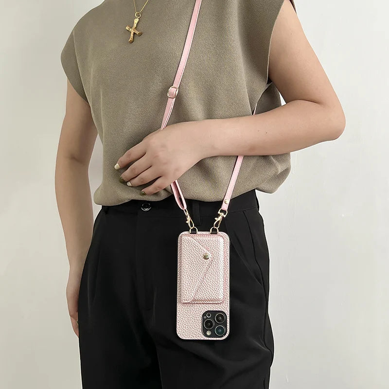 Person wearing a pink leather phone case with strap against a light background