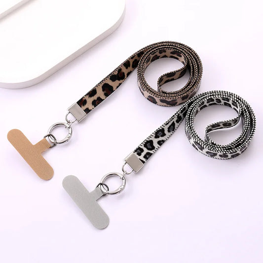 Leopard print lanyards with universal phone strap tethers on a white background