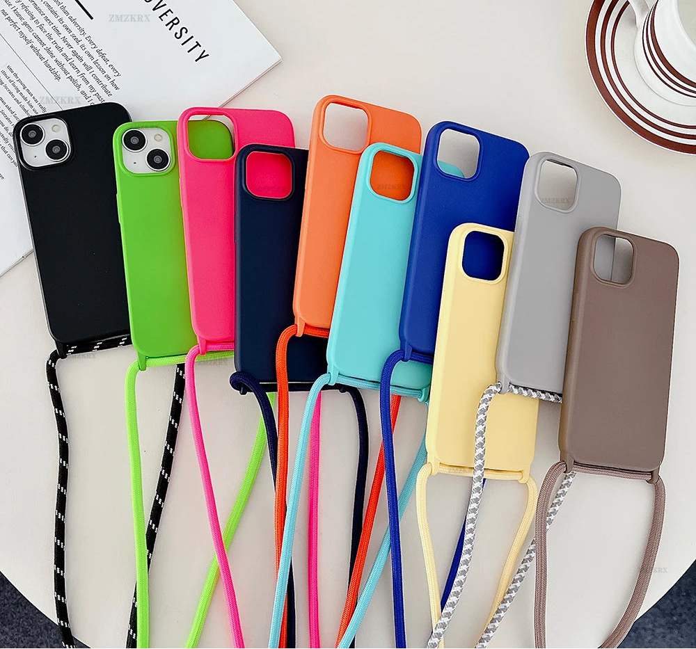 Colorful phone cases with straps on a white surface