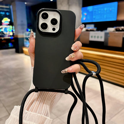 Person holding a black phone case with a lanyard in an indoor setting