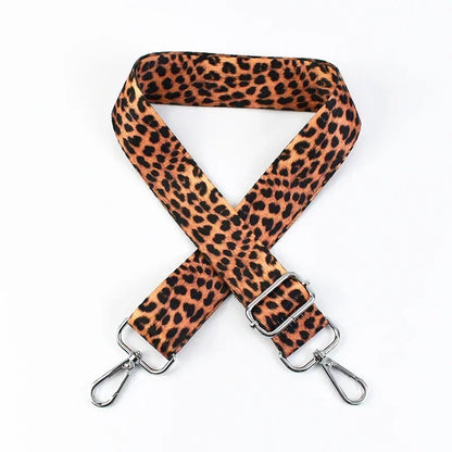 Cheetah print phone strap with metal clasps on a white background